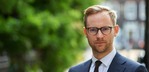 Man with glasses shirt. tie and blazer